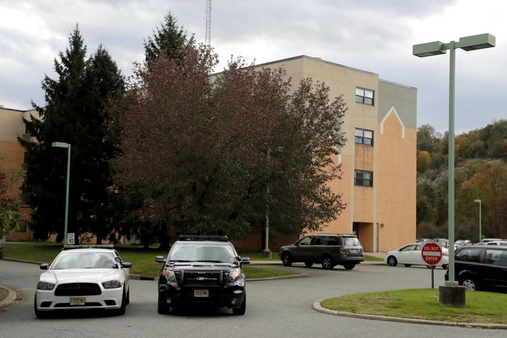 Police cruise ships seem parked near the entrance to the Wanaque hospitalization and rehabilitation center in Haskell, New Jersey