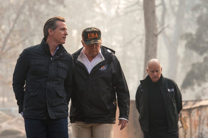 President Donald Trump talks with California Gov.-elect Gavin Newsom during a visit to a neighborhood destroyed by the wildfi