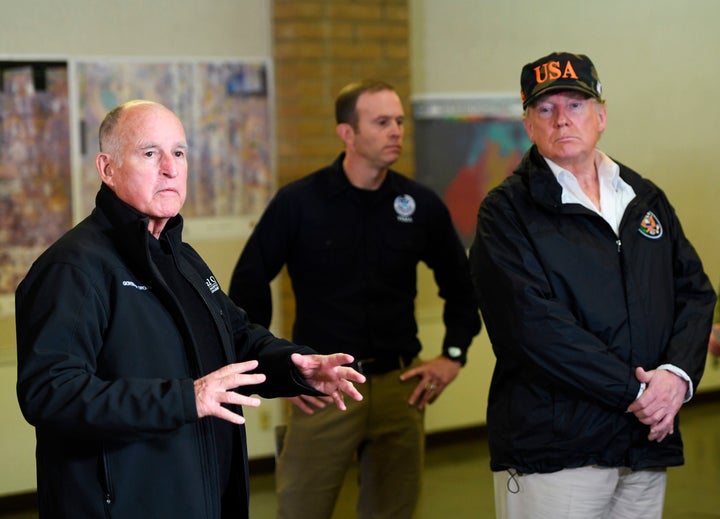 President Donald Trump looks on as the Governor of California Jerry Brown (L) speaks to the media at the Chico Command Center for the Camp fire in Chico, California on November 17, 2018. (SAUL LOEB/AFP/Getty Images)