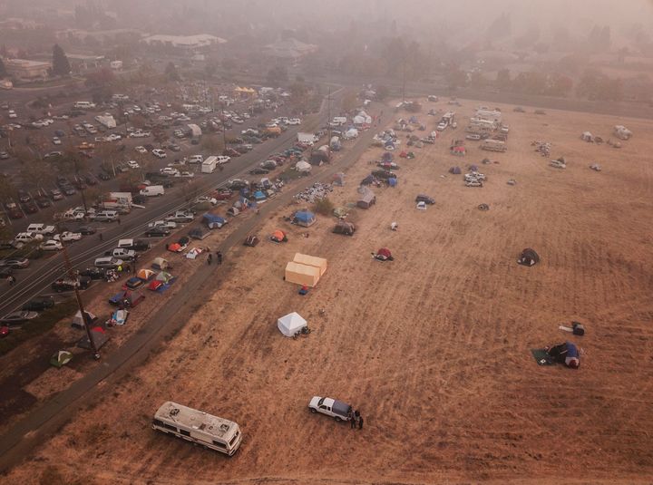 Evacuees from the Camp Fire shelter in tents outside the Walmart on November 16, 2018 in Chico, California. (Photo by Ricky Carioti/The Washington Post via Getty Images)