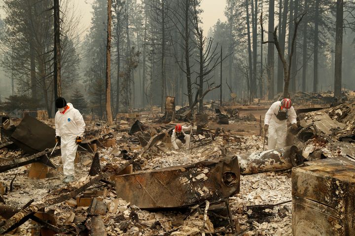 Search and rescue workers search for human remains at a trailer park burned by the Camp Fire in Northern California. 