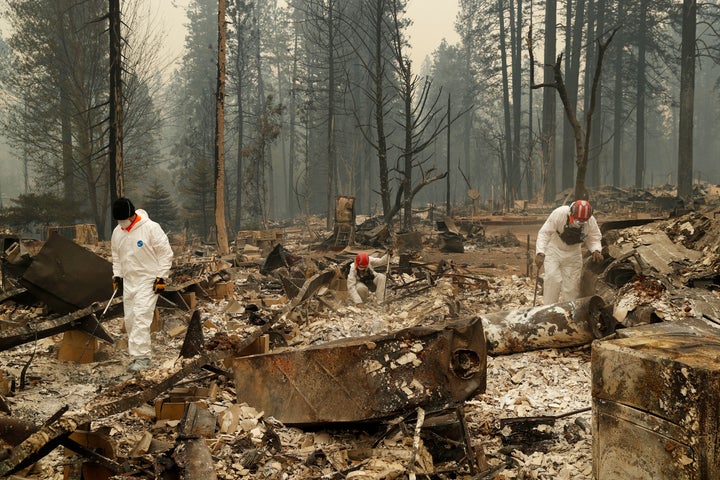 Search and rescue workers search for human remains at a trailer park burned by the Camp Fire in Northern California.
