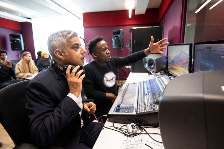 Khan put on headphones and watched how the sound engineers work with young people in the recording studio.