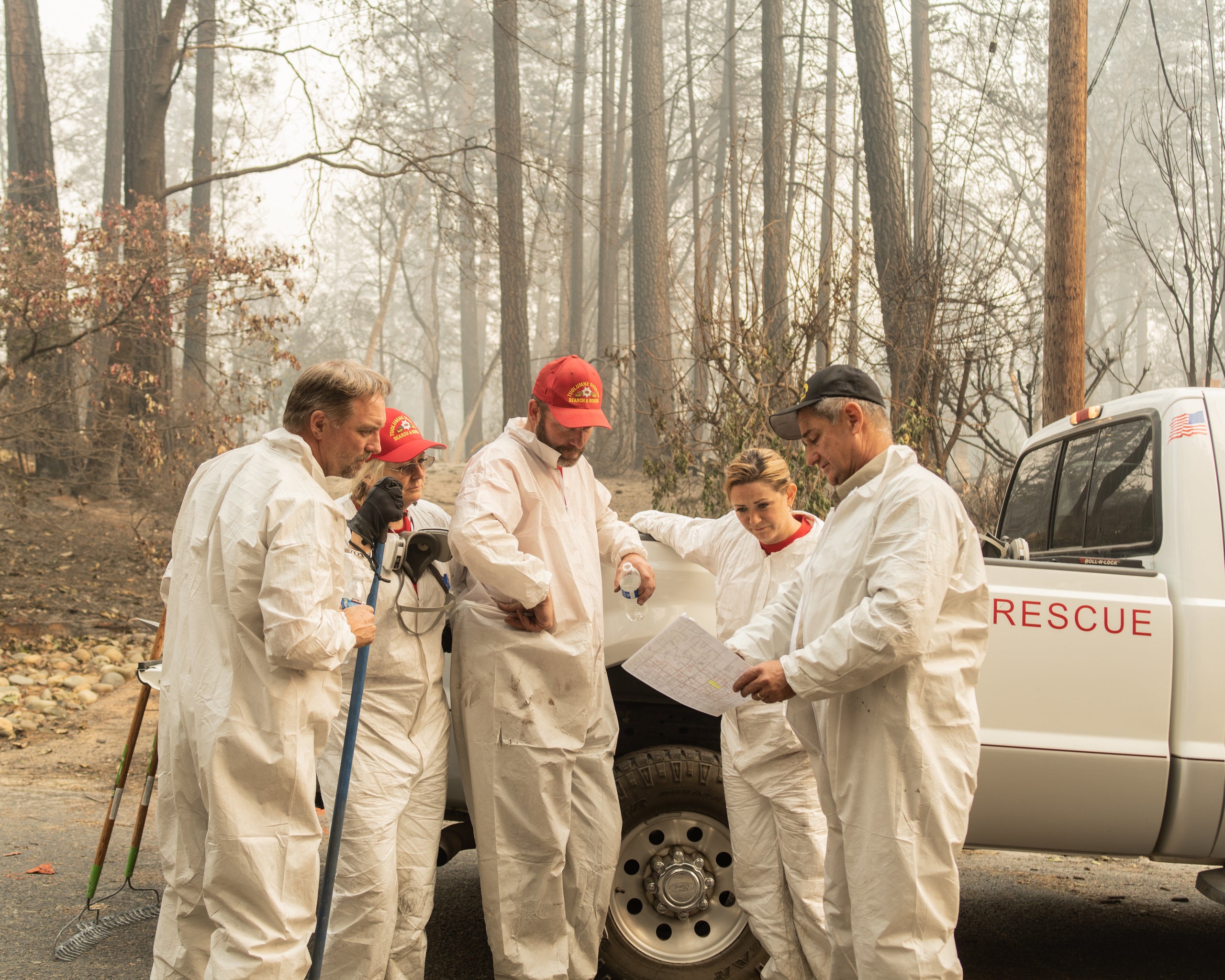 Search & Rescue Team members map their course through a neighborhood in Paradise.