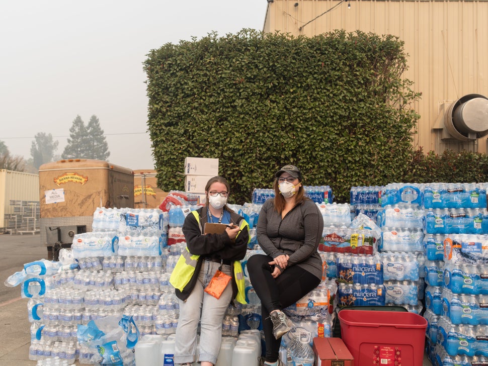 Kelsey Zimmer and Natalie Canida volunteer and coordinate relief efforts at the East Ave Church shelter.