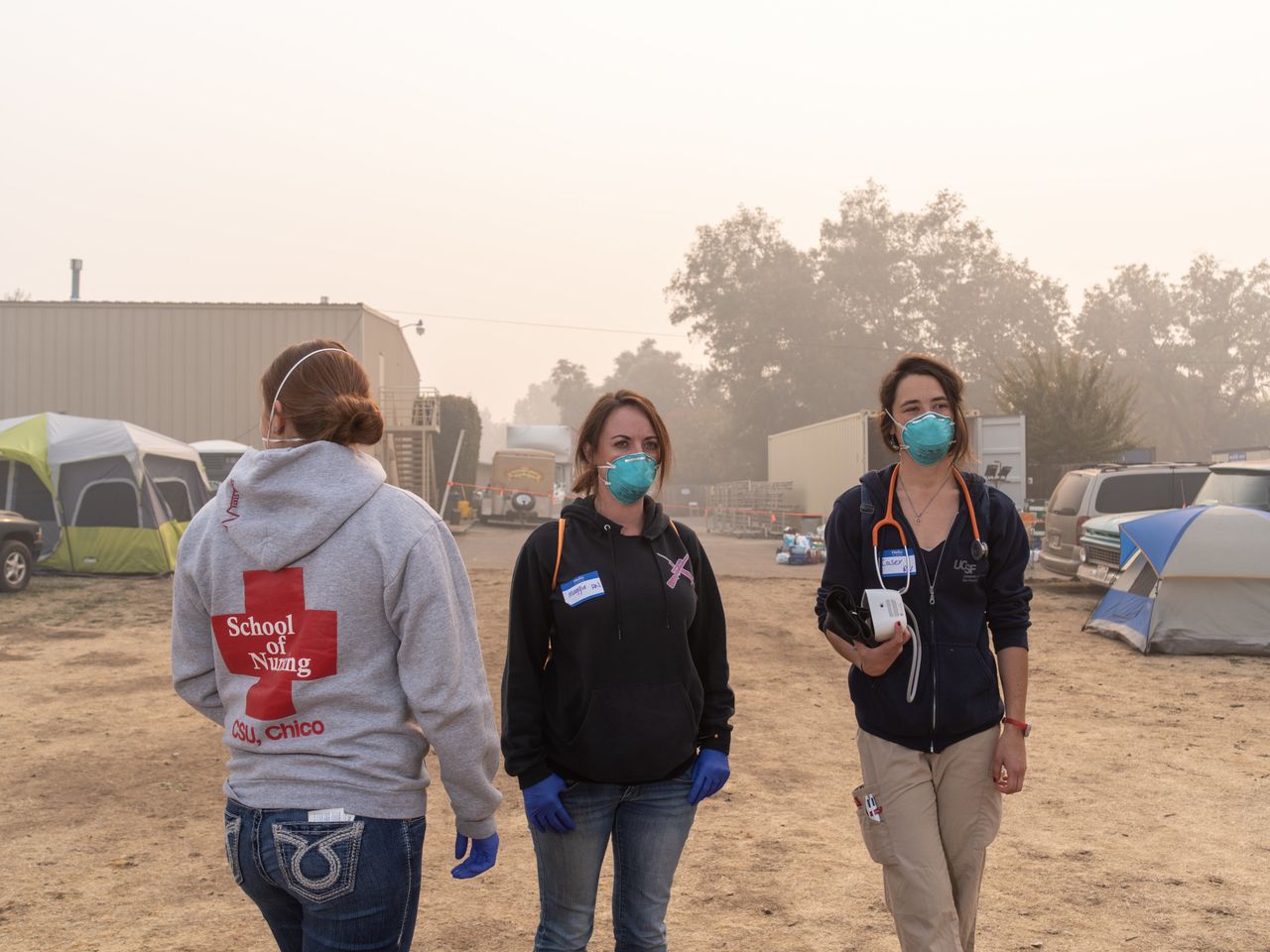 Sutter North RNs Jessica Garza and Maggie Page, along with UCSF RN Casey Domine, volunteer at the East Ave Community Church shelter, checking on victims of the Camp fire.
