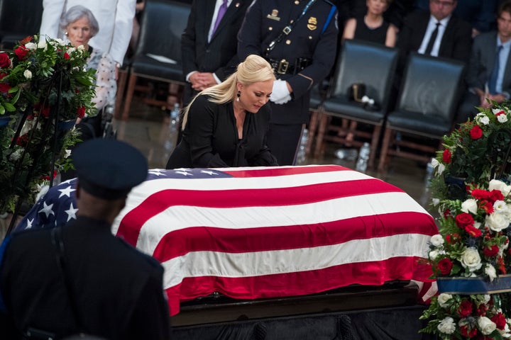 Meghan McCain knells at the coffin of her father, Sen. John McCain, R-Ariz., as he lays in state in the Capitol rot