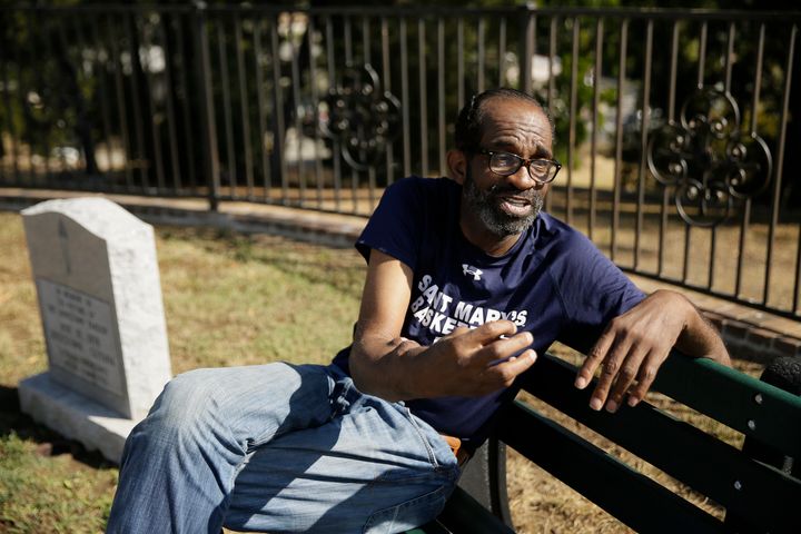 Jim Jones Jr., a former Peoples Temple member, speaks during an interview next to the Jonestown victim memorial in the Evergreen Cemetery in Oakland, California.