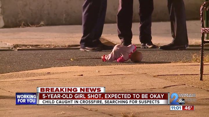 A baby doll, reportedly belonging to the 5-year-old shooting victim, is seen lying in a street after she was rushed to a hospital on Monday.
