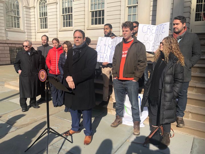 New York City Councilman Costa Constantinides, flanked by housing advocates and environmentalists, announces the introduction of his bill three months after he first said he'd draft legislation to cut emissions from big buildings 80 percent by 2050. 