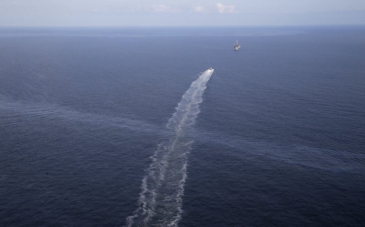An oil sheen from the site of the former Taylor Energy oil rig is seen in the wake of a supply vessel off the coast of Louisi