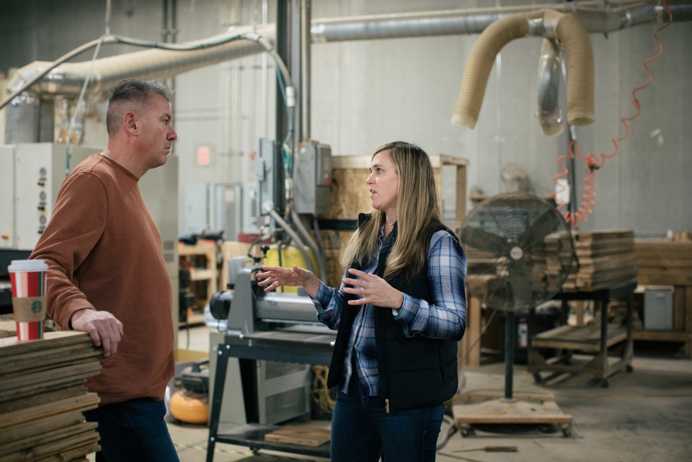 True speaks with her operations manager, Andrew Gebhardt, in the Urban Wood Goods shop.