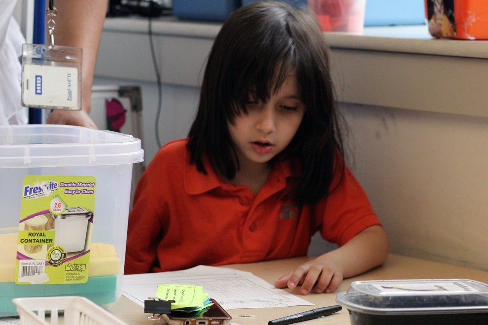Brandon's sister, Bella, works on a writing project in her first-grade classroom at the Mott Haven Academy Charter School.&nb