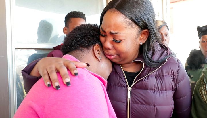 Bernice Parks, left, is consoled after her daughter Sandra was killed by a stray bullet in her home on Monday