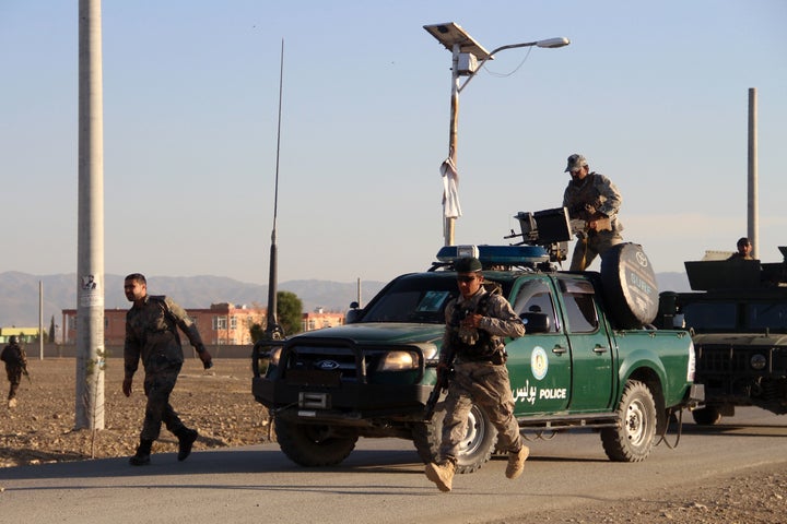 Afghan security forces arrive near the site after a suicide bomber blew himself up inside a packed mosque on an Afghan army b