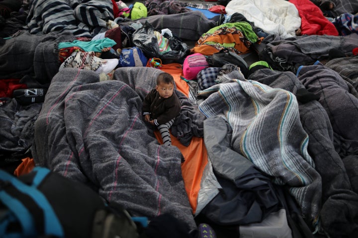 Members of a caravan from Central America trying to reach the United States sleep under a road bridge next to the U.S.-Mexico border in Tijuana, Mexico.