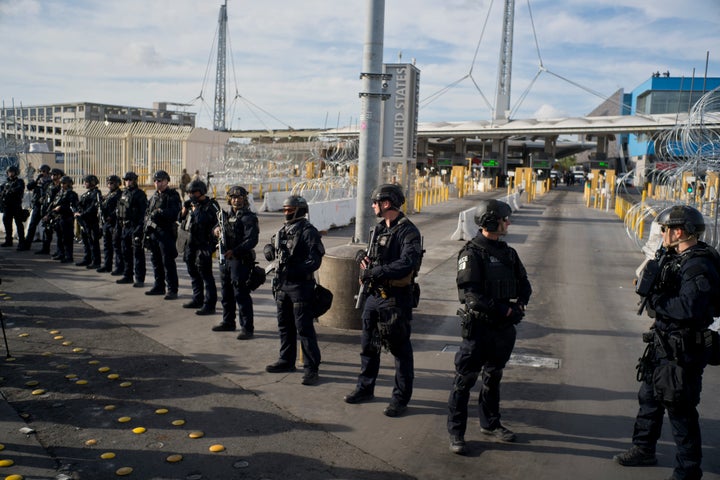 U.S. Customs and Border Protection agents stand guard at the San Ysidro port of entry on the U.S.-Mexico border, seen from Tijuana, Mexico.