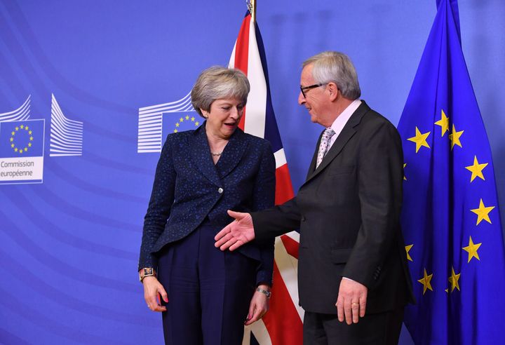 European Commission President Jean-Claude Juncker, right, reaches out to shake hands with British Prime Minister Theresa May prior to a meeting at EU headquarters in Brussels, Saturday, Nov. 24, 2018. 