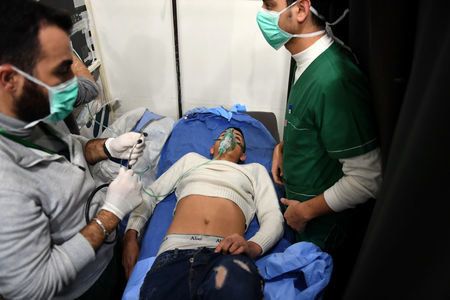 A man breathes through an oxygen mask inside a hospital after what the Syrian state media said was a suspected toxic gas attack in Aleppo.