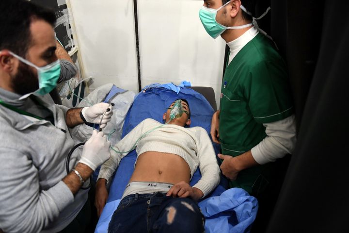 A man breathes through an oxygen mask inside a hospital after what the Syrian state media said was a suspected toxic gas attack in Aleppo, Syria, on November 24, 2018.
