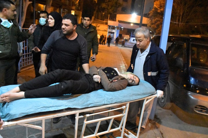 A woman lies on a stretcher after what the Syrian state media said was a suspected toxic gas attack in Aleppo, Syria, on November 24, 2018. 