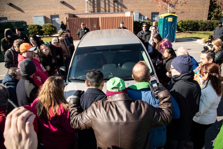 Demonstrators surround a government vehicle after Samuel Oliver-Bruno, 47, an undocumented Mexican national, was arrested Fri