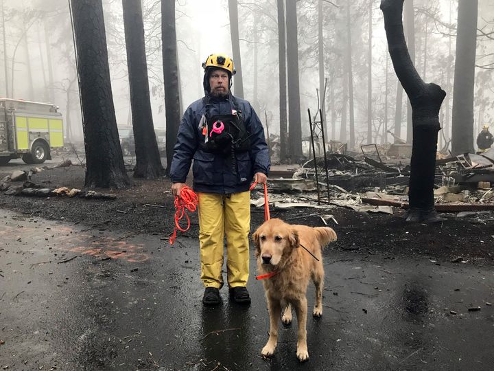 Eric Darling and his dog are part of a search team from Orange County, California. Theirs is one of several teams conducting a second search of a mobile home park after the deadly Camp fire in Paradise.