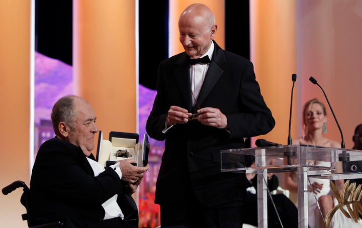 Italian Director Bernardo Bertolucci, left, receives a 'Palme d'Honneur' from President of the Cannes Film Festival Gilles Jacob during the opening ceremony for the 64th international film festival, in Cannes, southern France, on May 11, 2011.