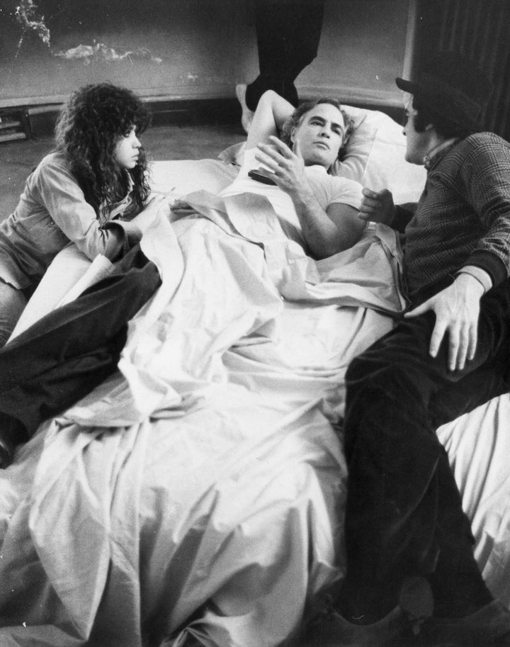 American actor Marlon Brando (center) with actress Marie Schneider (left) and Bernardo Bertolucci (right) in Bertolucci's fil