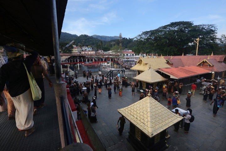 Devotees carrying customary offerings on their heads arrive to worship at the Sabarimala temple, one of the world's largest Hindu pilgrimage sites in Kerala state, India, on Nov. 5. The historic temple, which had barred women age 10 to 50 from entering, opened to Hindu pilgrims for a day. The last time it was opened, conservative protesters blocked women of menstruating age from going to the temple, defying a recent ruling from India's top court to let them enter. 