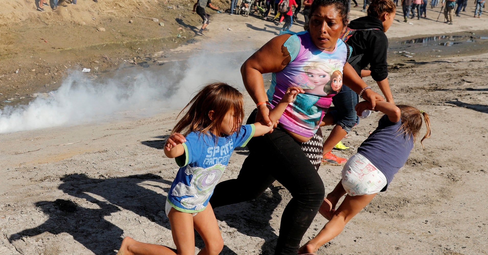 Image result for migrant child fence cage tear gas fleeing