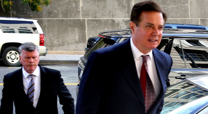 Former Trump campaign chairman Paul Manafort (right) secretly met with WikiLeaks founder Julian Assange on multiple occasions, according to The Guardian.