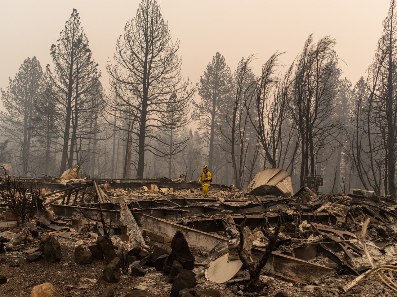 A Cal Fire firefighter assess damage at Ridgewood one week after the blaze destroyed Paradise, California.