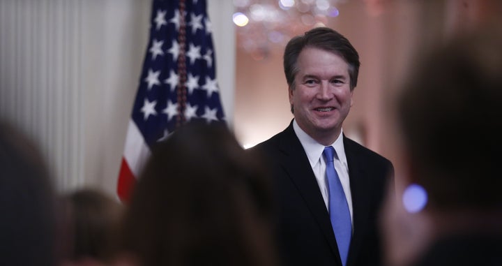 Brett Kavanaugh, associate justice of the U.S. Supreme Court, smiles as U.S. President Donald Trump speaks during a ceremonial swearing-in event in the East Room of the White House in Washington, D.C., U.S., on Monday, Oct. 8, 2018. 