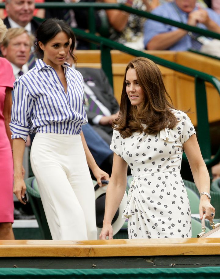 Kate, Duchess of Cambridge and Meghan, Duchess of Sussex, left, take their seats in the Royal Box on Centre Court at the Wimbledon on July 14. 