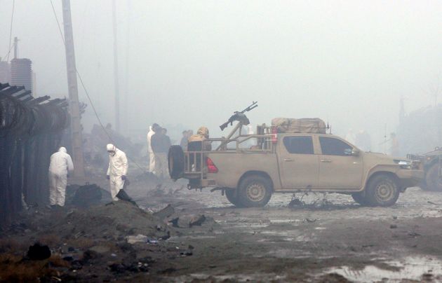 Security forces inspect the site of the suicide bomb attack.