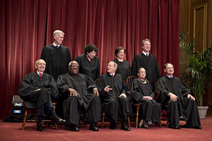 Seated from left to right in the bottom row are Associate Justice Stephen Breyer, Associate Justice Clarence Thomas, Chief Justice John Roberts, Associate Justice Ruth Bader Ginsburg and Associate Justice Samuel Alito.