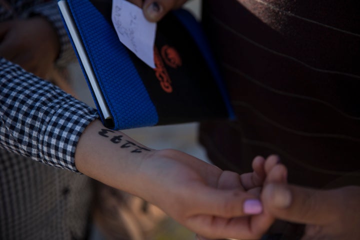 A woman from southern Mexico holds out her arm where administrators at Casa Del Migrante wrote a number on her arm to hold her place in a growing list of asylum-seekers in Juarez, Mexico on November 29, 2018. The current status of the list was nearing 1,100 people that had been taken to Customs and Border Patrol agents at the ports of entry in Juarez area. (Photo: Adria Malcolm for Yahoo News)