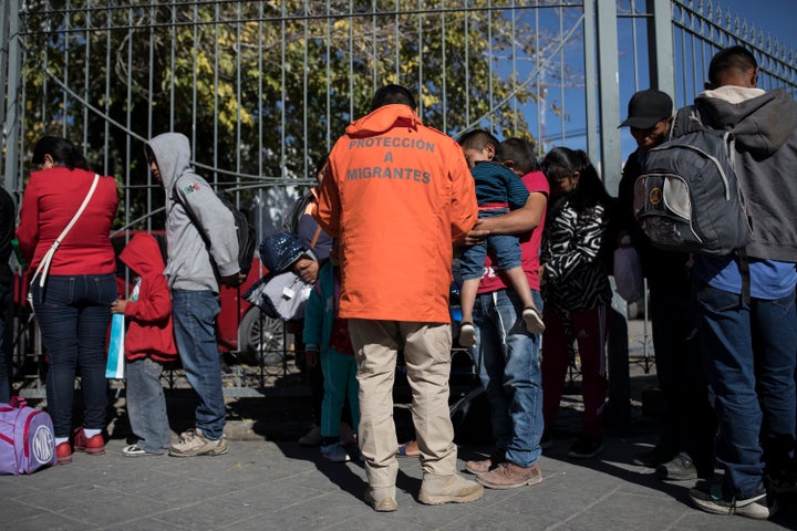 A representative from Grupos Beta collects the names and list numbers from asylum-seekers after they arrived in a group of 30 from Casa Del Migrante in Juarez, Mexico on November 28, 2018. (Photo: Adria Malcolm for Yahoo News)