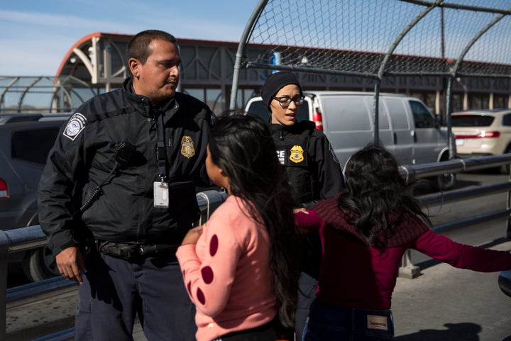 Customs and Border Patrol agents stop a woman and her daughter at the International Boundary Line of the Paso Del Norte Port of Entry between Juarez and El Paso on November 28, 2019. The mother did not verbally declare asylum to the agents before a private security officer explained they sign up to be put on “the list” for entry to ask for asylum. (Photo: Adria Malcolm for Yahoo News)