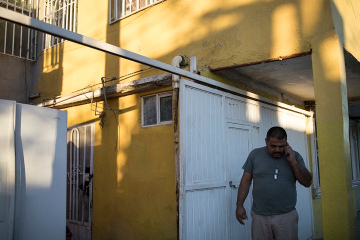 Alex Varela talks on his phone after taking a woman and her three children to his relative’s home in Juarez, Mexico on November 28, 2018. (Photo: Adria Malcolm for Yahoo News)