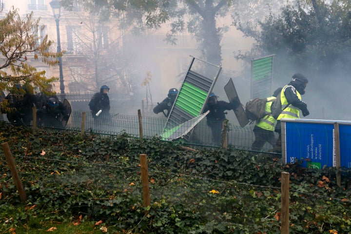 Riot police were seen chasing protesters near the French capital's Arc de Triomphe.