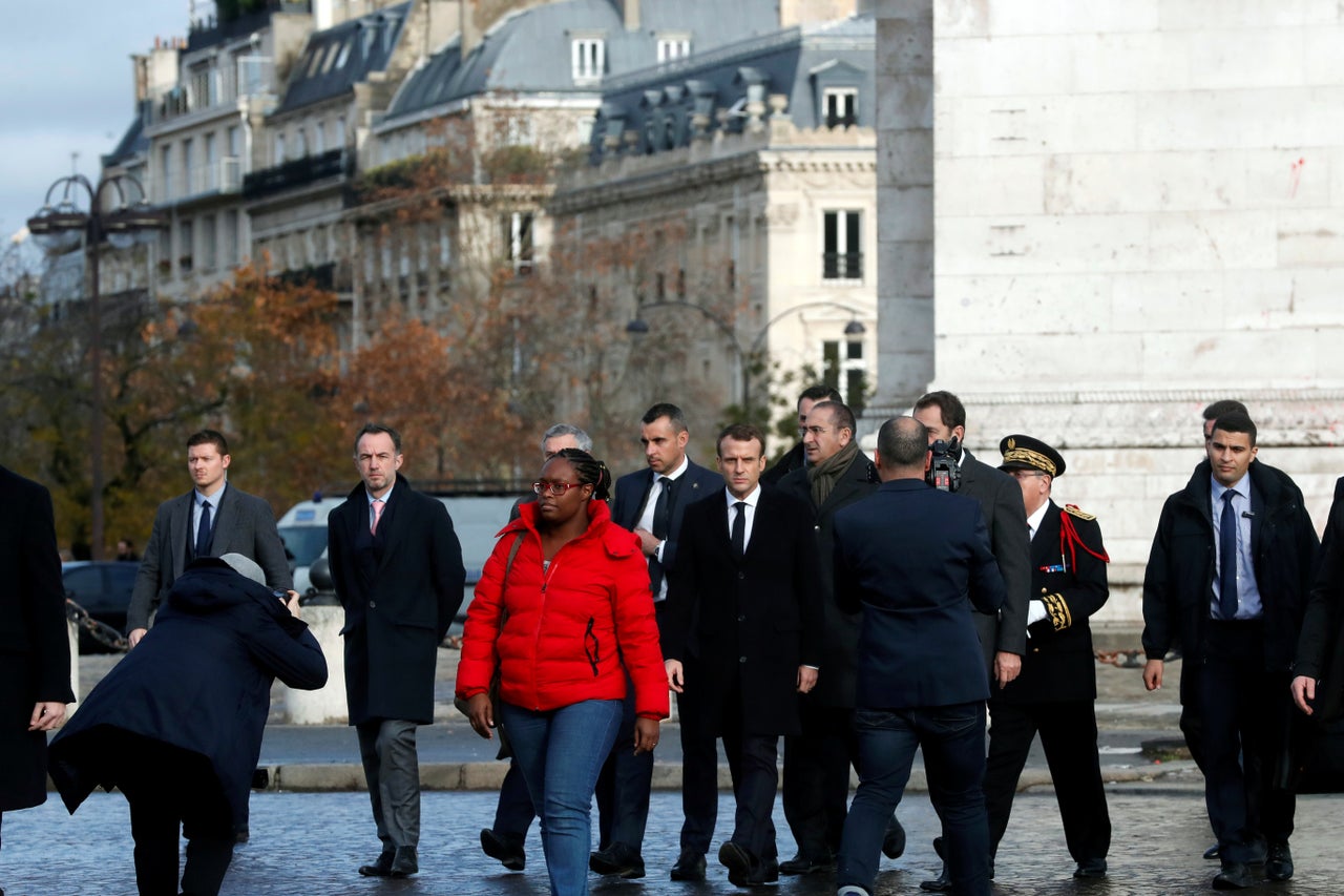 French President Emmannuel Macron leaves the Arc de Triomphe on Sunday after inspecting damage during Saturday's riots.