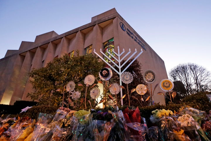 A menorah is installed outside the Tree of Life Synagogue in preparation for a celebration service at sundown on the first night of Hanukkah, Sunday, Dec. 2, 2018 in the Squirrel Hill neighborhood of Pittsburgh. A gunman shot and killed 11 people while they worshipped Saturday, Oct. 27, 2018 at the temple. (AP Photo/Gene J. Puskar)