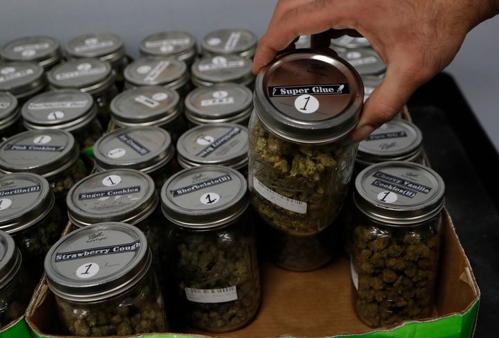 An attendant holds a mason jar of marijuana at a dispensary in Detroit, Michigan, where recreational marijuana has been legalized. Utah's law won't allow people with prescriptions to smoke the drug but they can obtain it in pill form or oils.