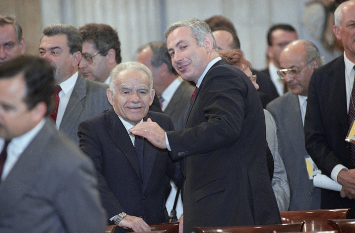 Then-Israeli Prime Minister Yitzhak Shamir, left, confers with his Deputy Foreign Minister Benjamin Netanyahu at the Madrid peace conference in October 1991.