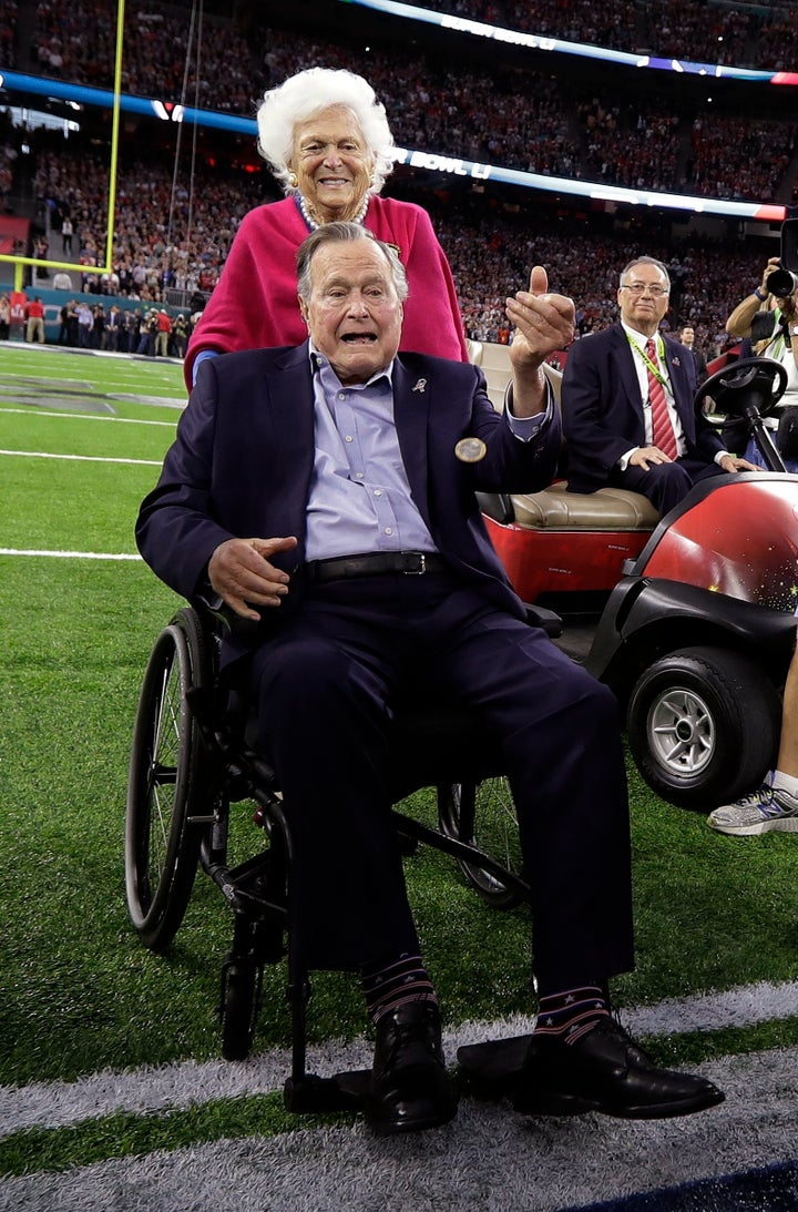Former President George H.W. Bush and wife, Barbara, walk off the field before the NFL Super Bowl 51 football game between th