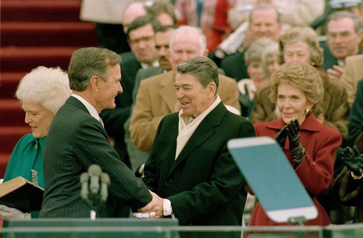 Ronald Reagan congratulates his successor and former vice president, George H.W. Bush, at Bush's inauguration in 1989.