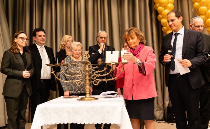 German politicians, Jewish leaders and Holocaust survivors light a menorah at a Jewish community center in Berlin.