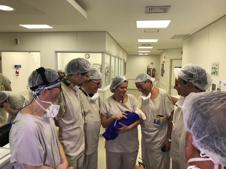 A medical team at Brazil’s Sao Paulo University hospital holds the first baby born via uterus transplant from a deceased donor on December 15, 2017.